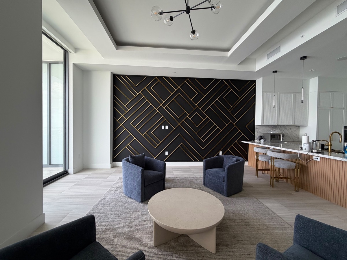 Dark herringbone accent wall in an open-plan living room
